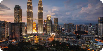 An aerial view of a city skyline at night with the twin towers in the foreground.