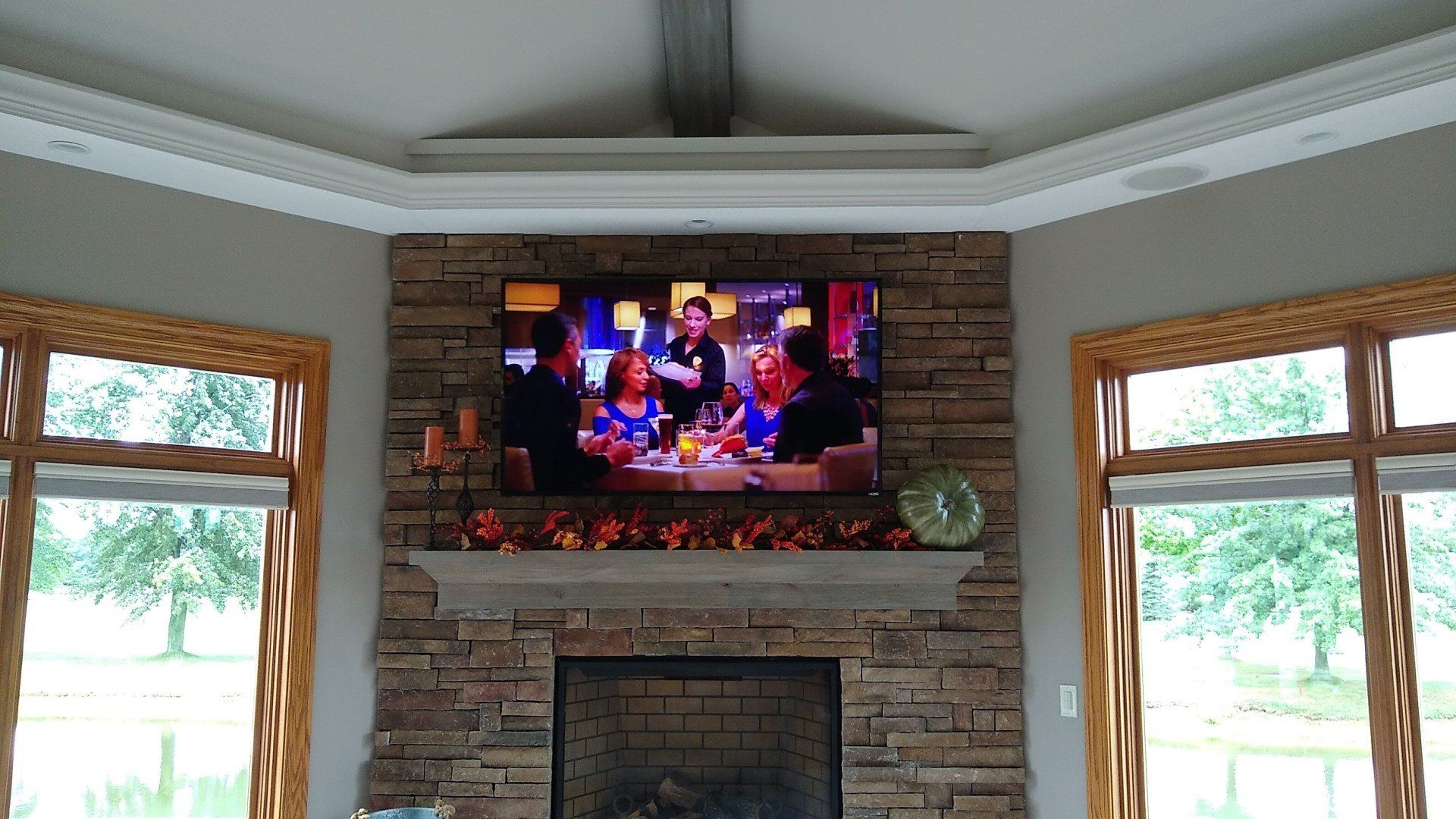 a fireplace with a flat screen TV mounted above it in north central ohio