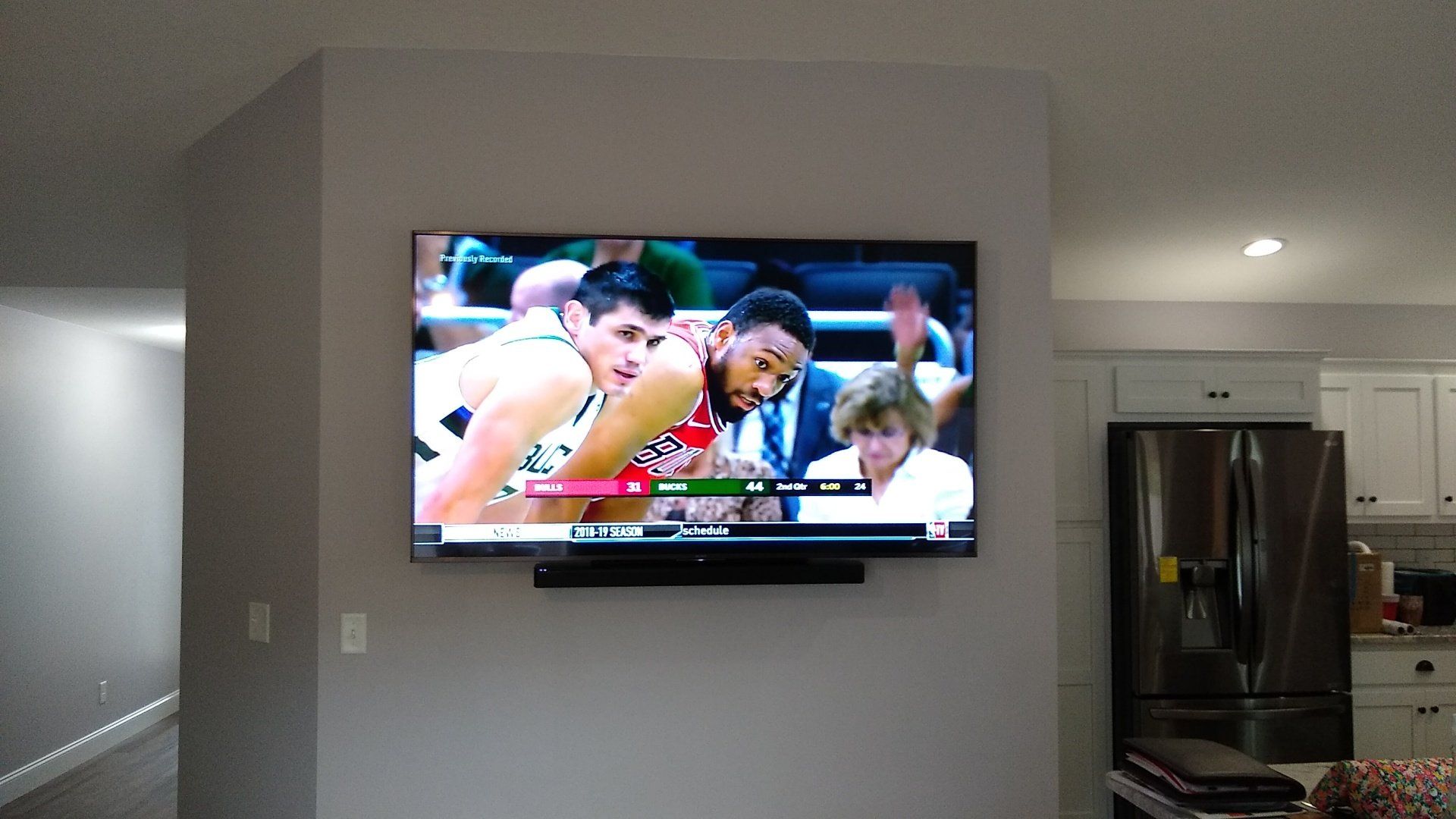 a TV and soundbar mounted on the wall in north central ohio