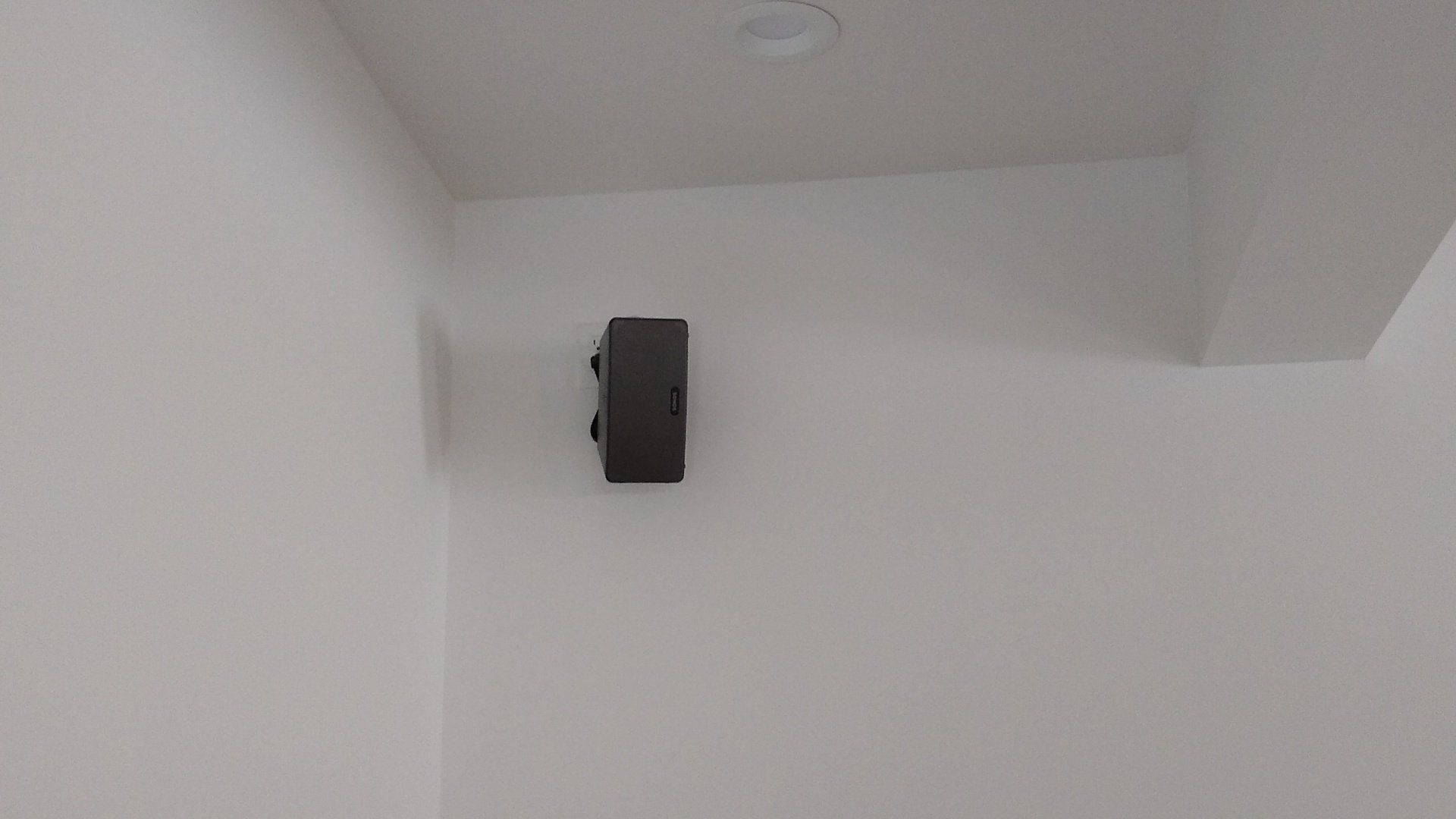 A black sonos speaker mounted on a wall by fisher electronics in northern ohio.