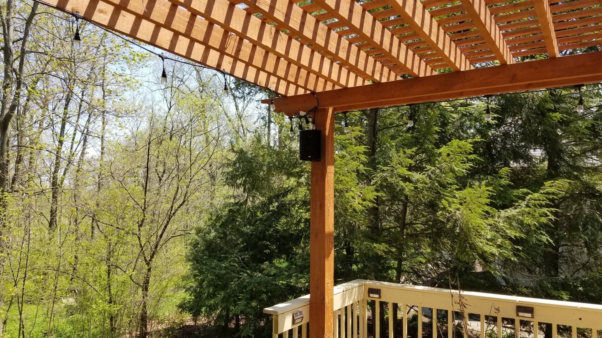 a deck with a pergola and outdoor speakers with Sonos audio installed by fisher electronics in northern ohio.