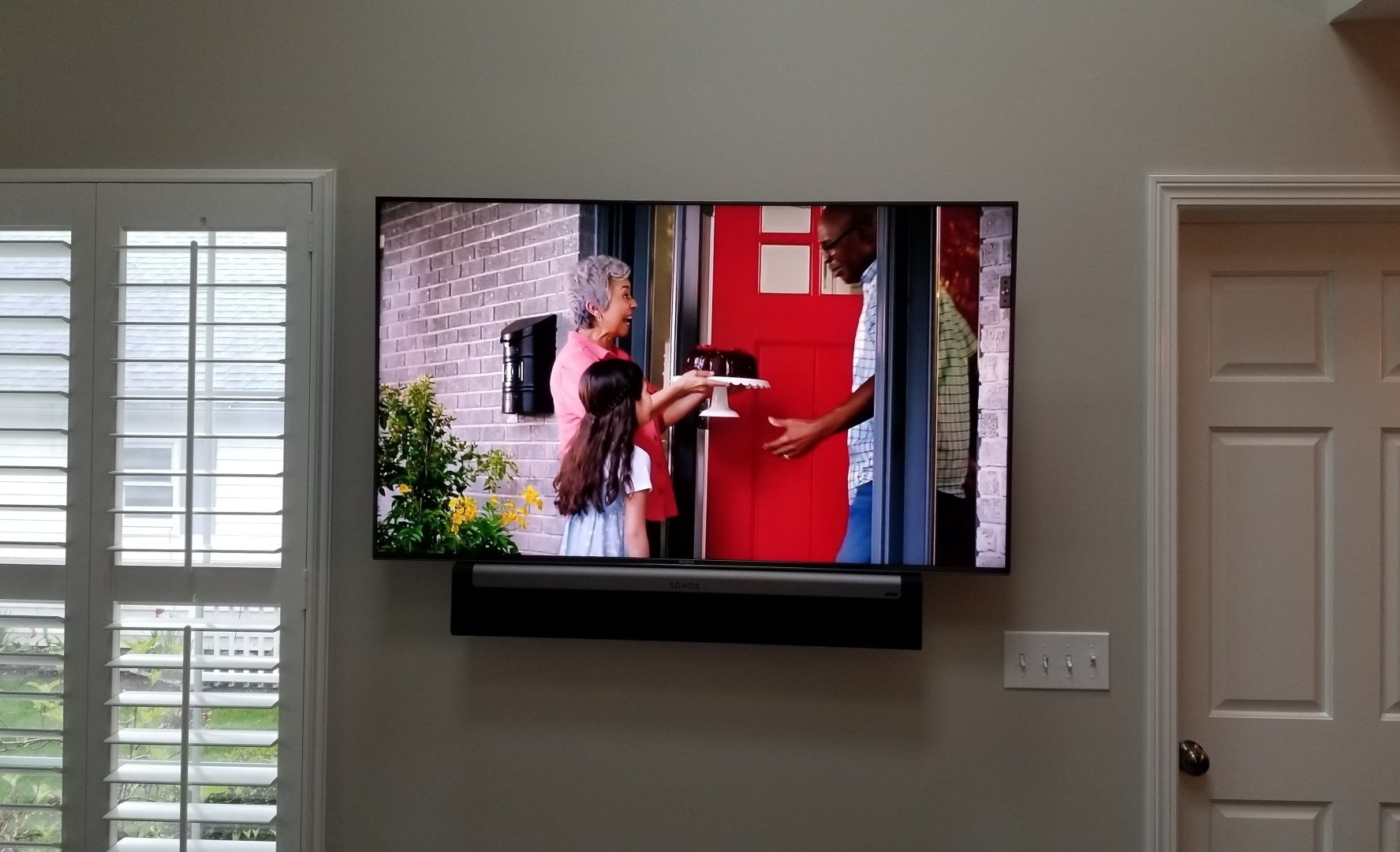 a television is mounted on a wall with a sonos soundbar installed by fisher electronics in northern ohio.