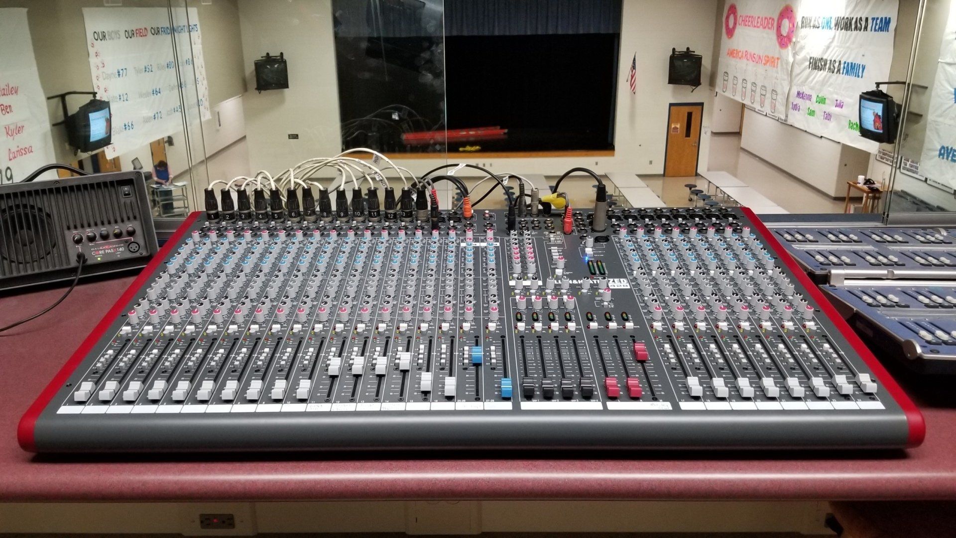 a large audio mixer sits on a table in front of a stage in northern ohio
