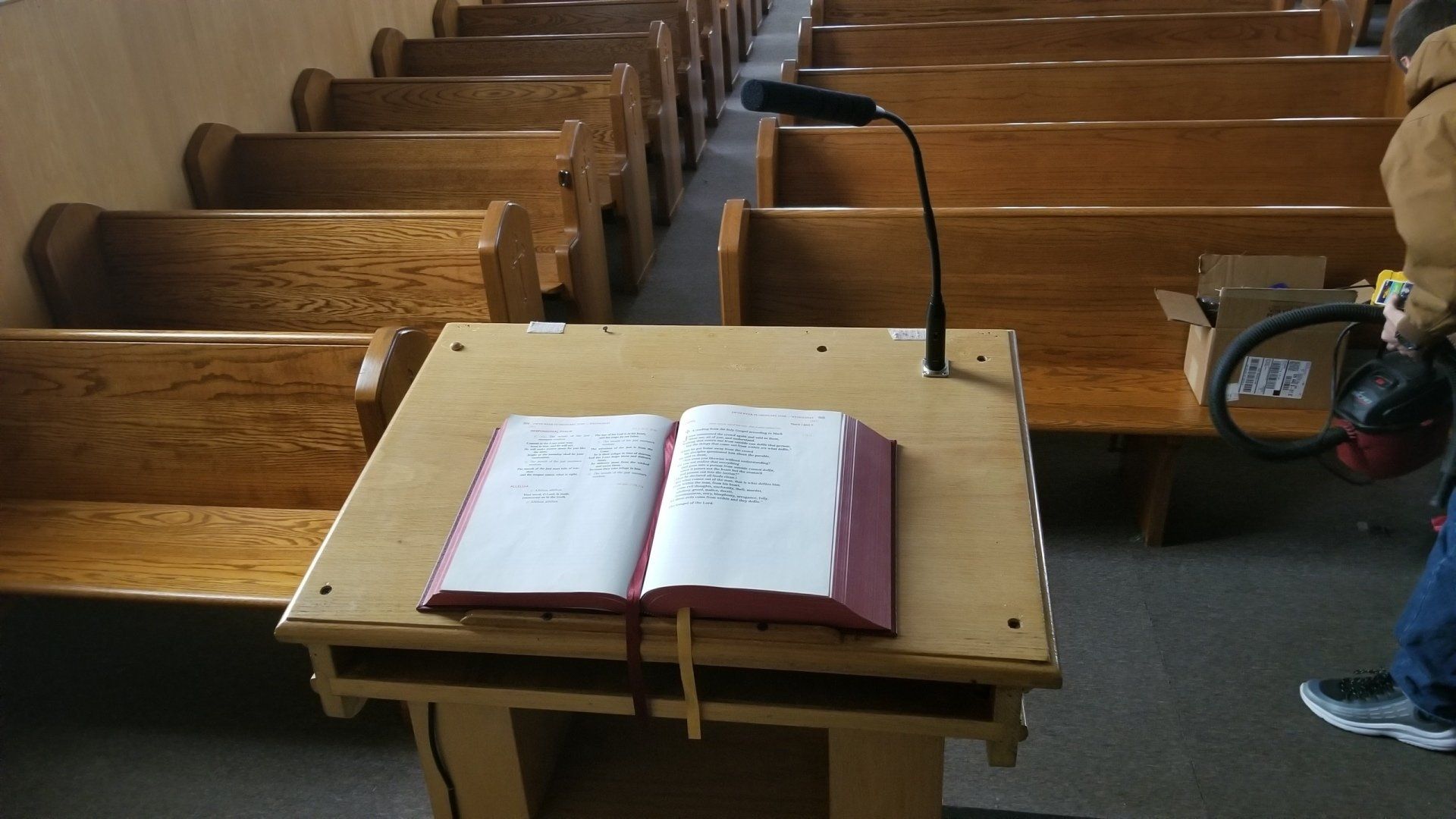 an open bible sits on a wooden podium in a church with the new microphone for church audio in northern ohio