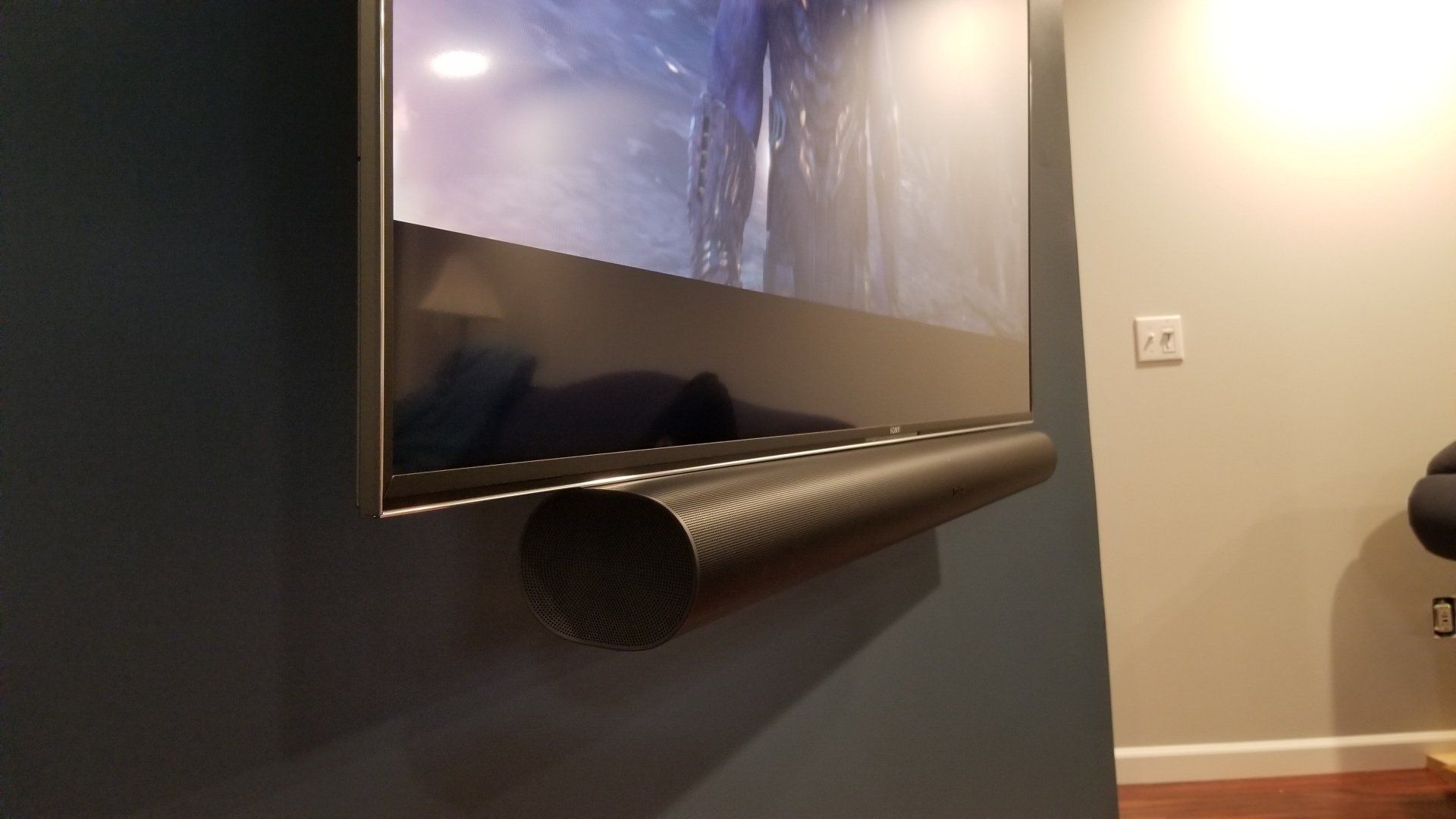 a tv is mounted to a wall with a sonos arc attched to it by fisher electronics in northern ohio