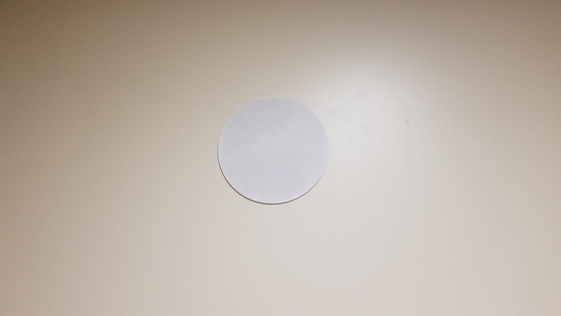 a white speaker is mounted in a white wall for audio in northern ohio