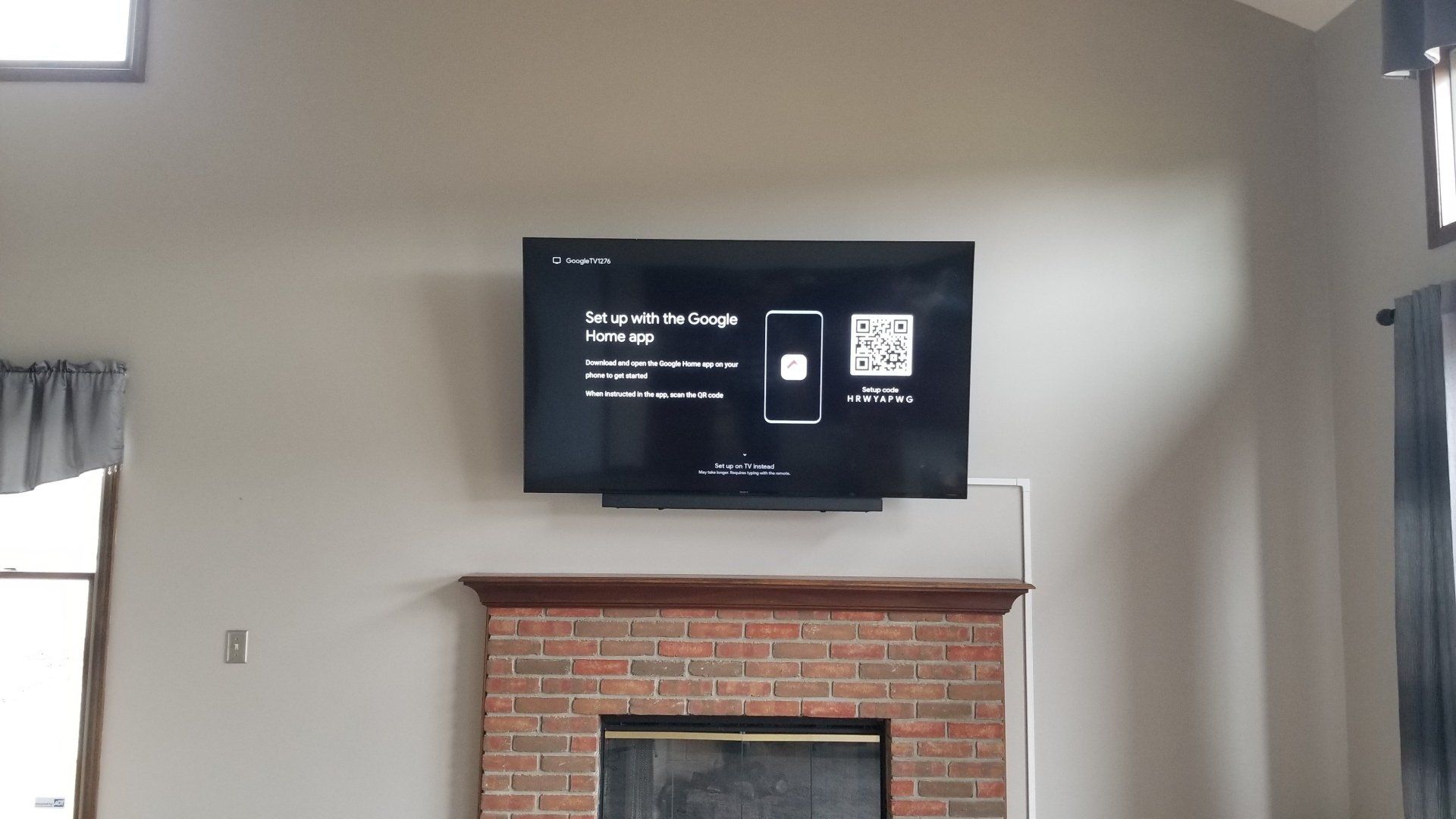 A TV that is mounted above a fireplace in north central ohio