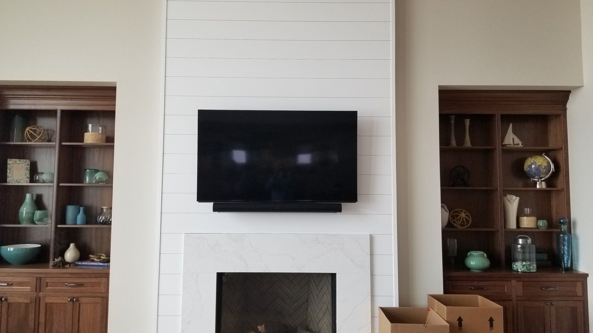 a flat screen tv and sonos arc mounted above a fireplace in north central ohio