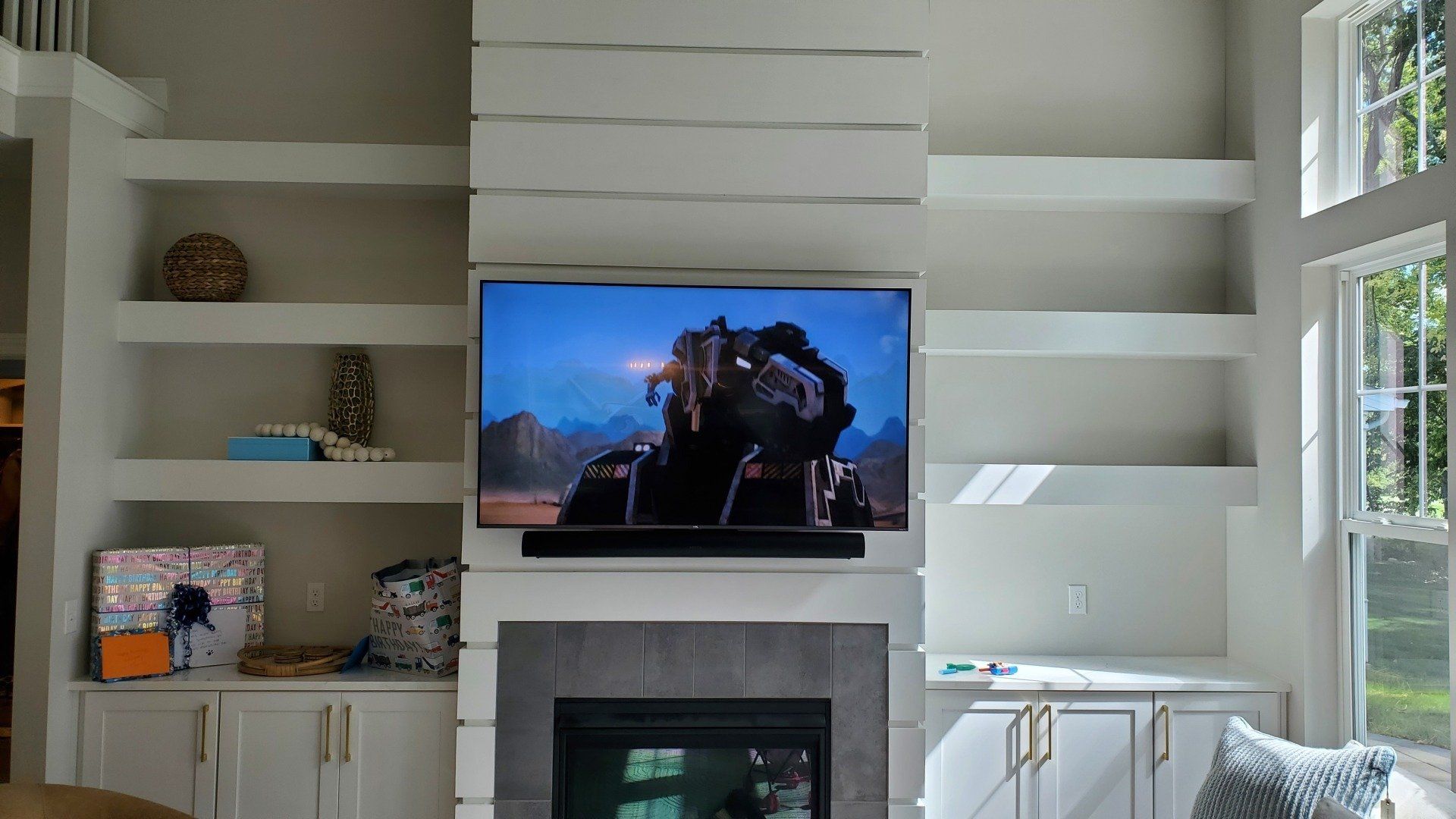 A living room with a fireplace and a flat screen tv mounted above it in fremont ohio