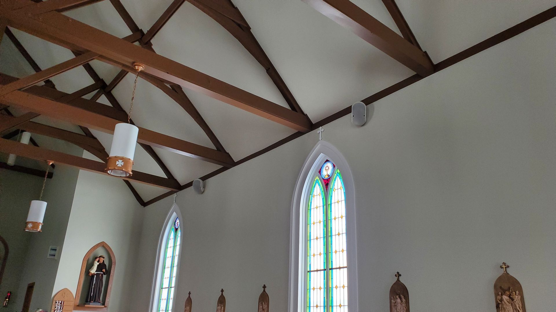 the inside of a church with stained glass windows and new speakers installed on the walls in northern ohio