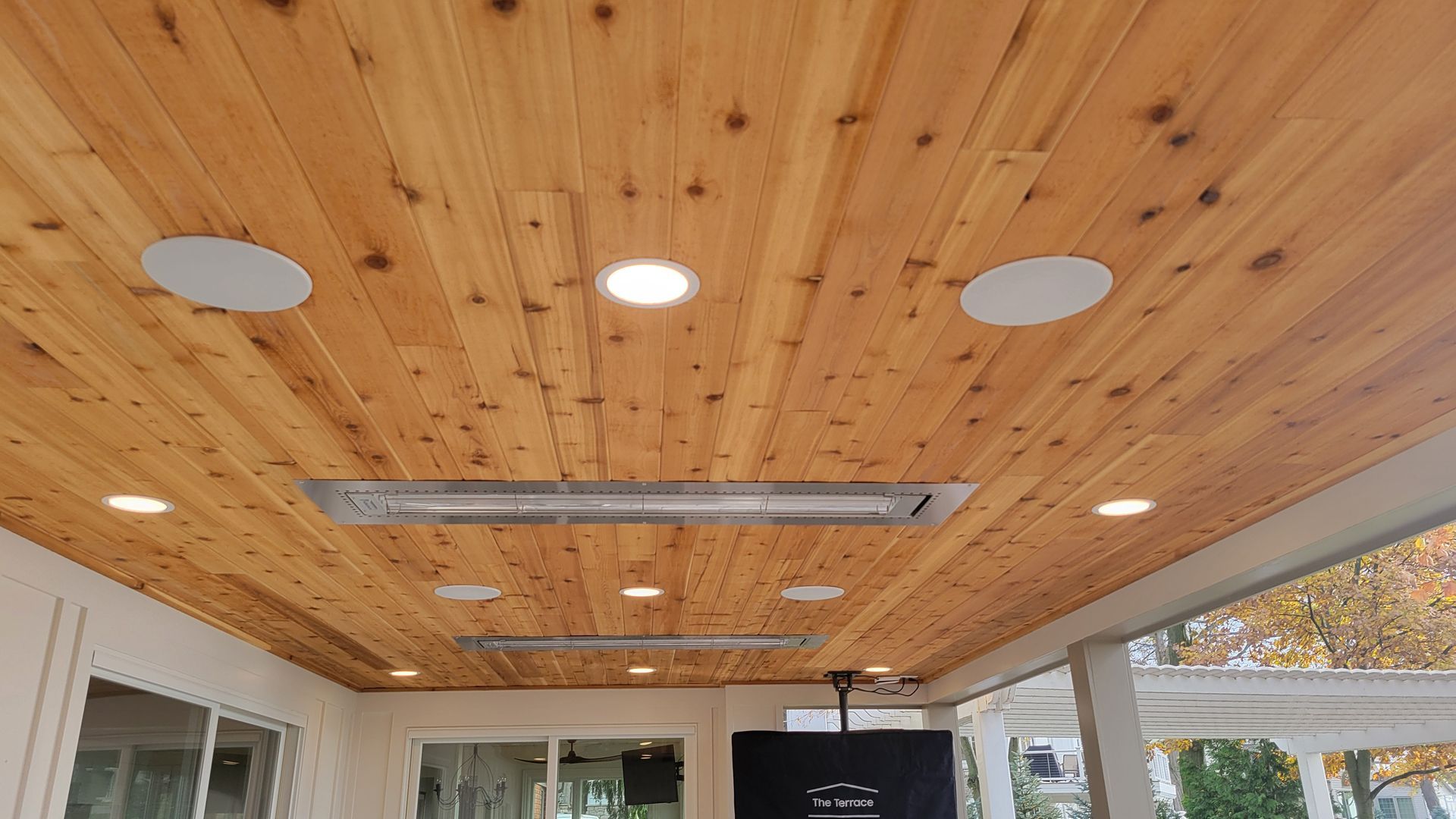 A wooden ceiling with an outdoor tv hanging from it, and recessed outdoor speakers in marblehead ohio