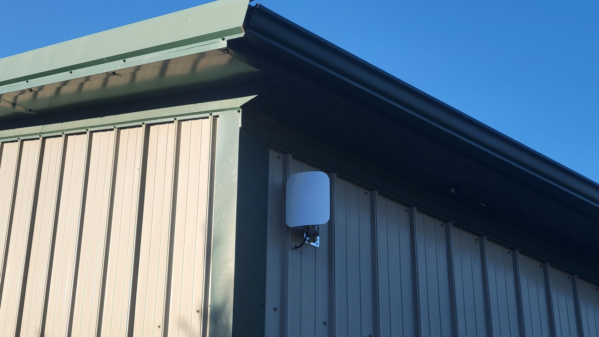 A garage with an outdoor eero 7 wifi access point installed on it near sandusky ohio