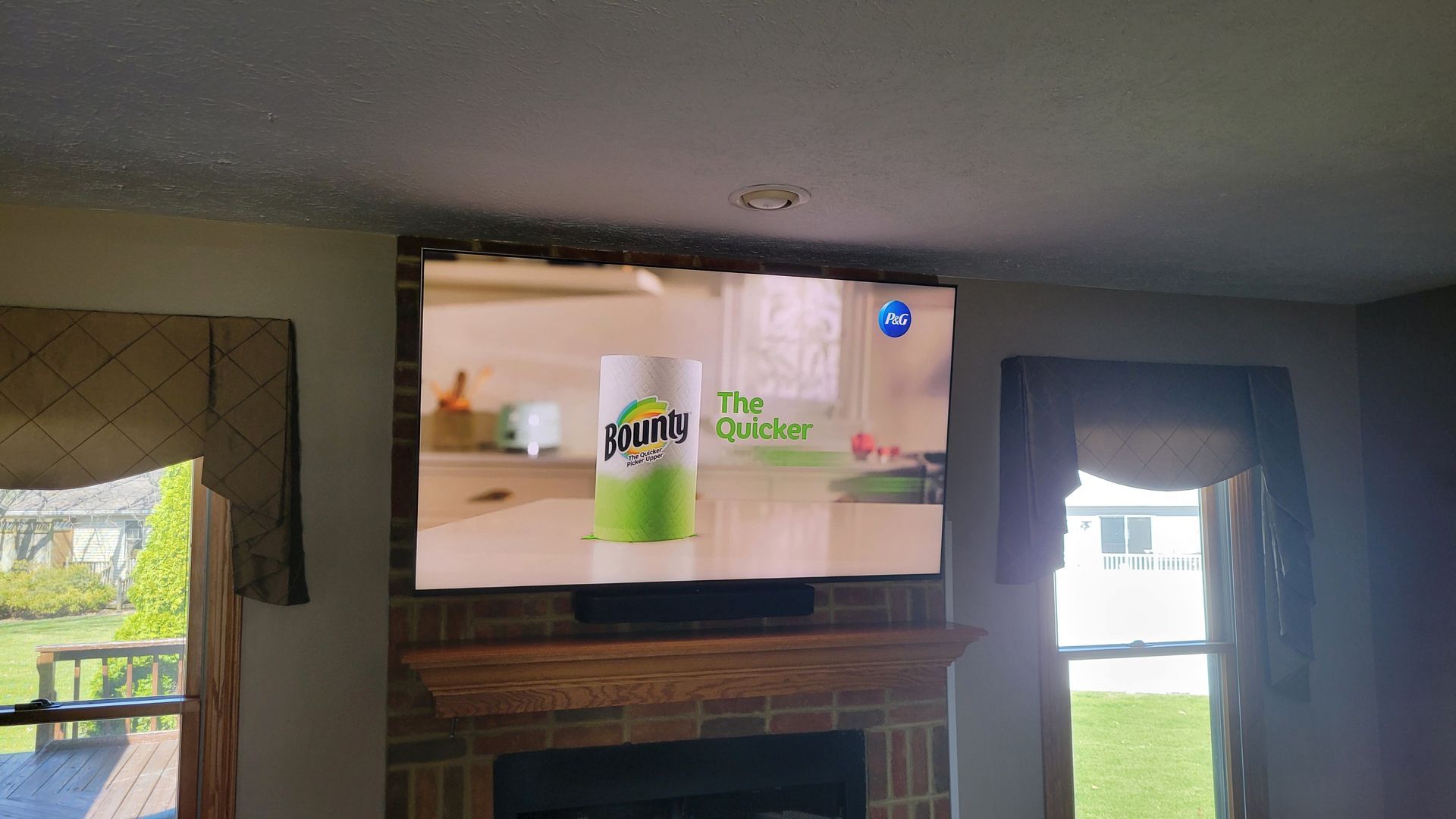 A fireplace with a flat screen tv and sonos soundbar mounted on it