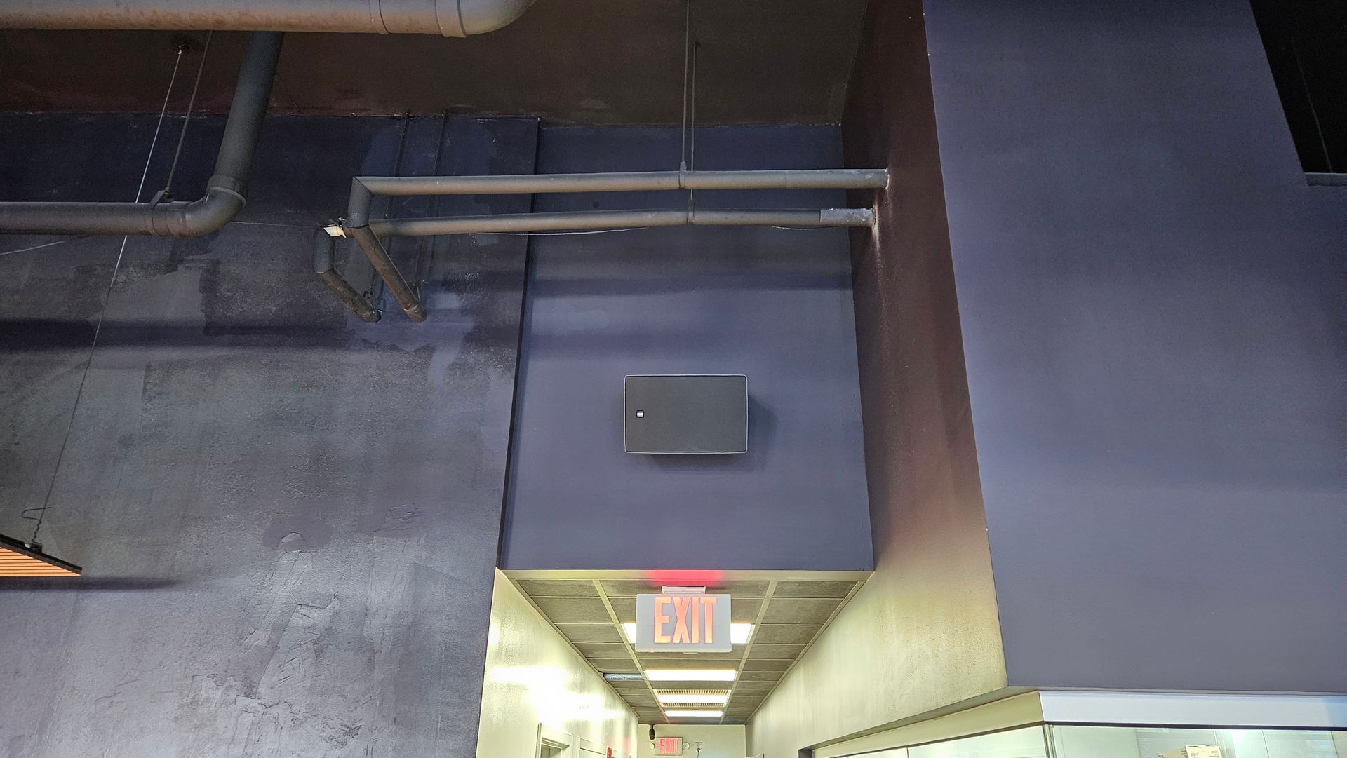 Restaurant Hallway with exit sign, and speaker installed