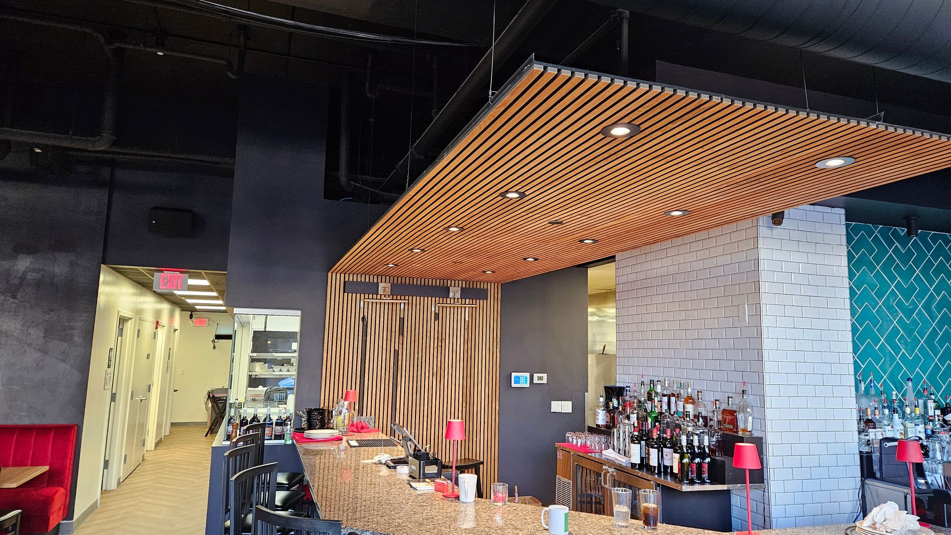 Interior view of a restaurant. Wooden ceiling detail. With a speaker installed above the hallway