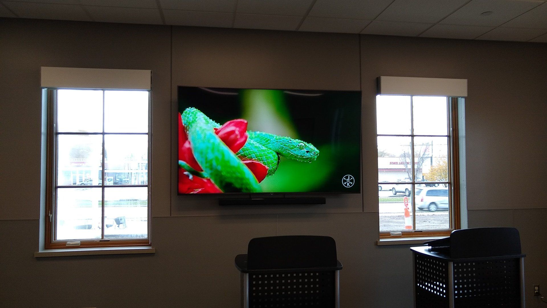 a TV screen mounted on a wall with a soundbar installed in north central ohio