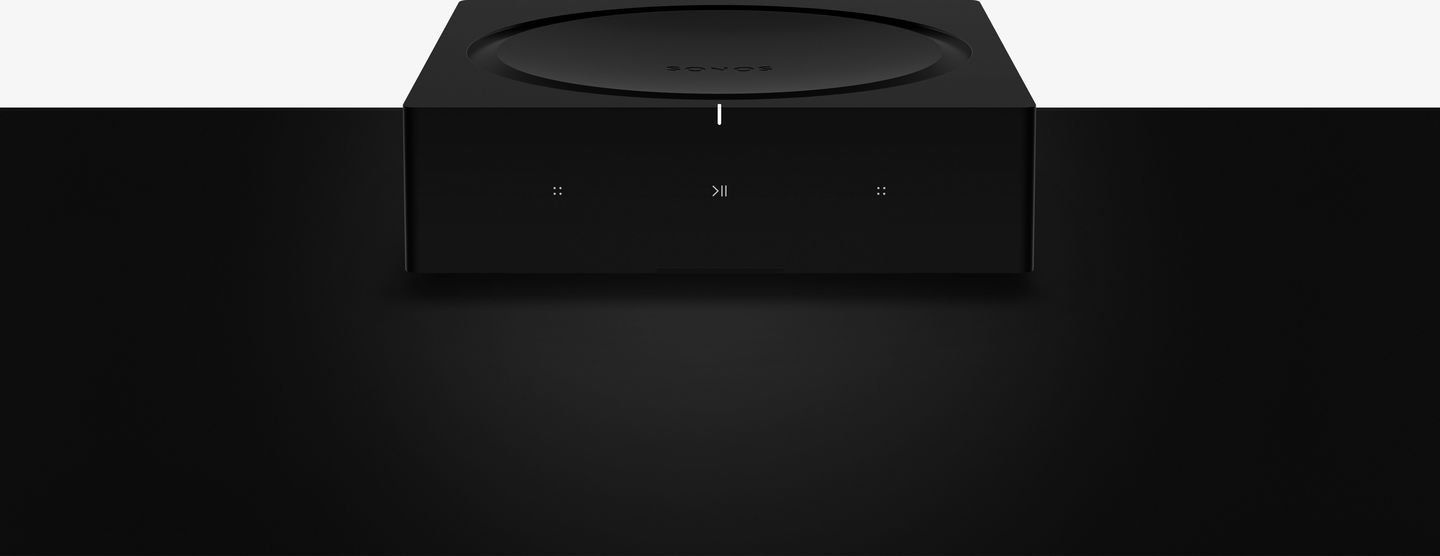 a sonos amp is sitting on a black surface