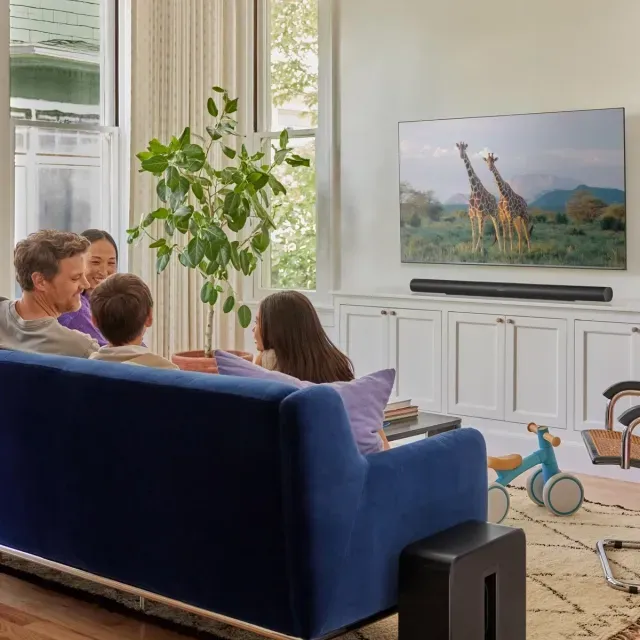 A flat screen tv is sitting on top of a wooden entertainment center.