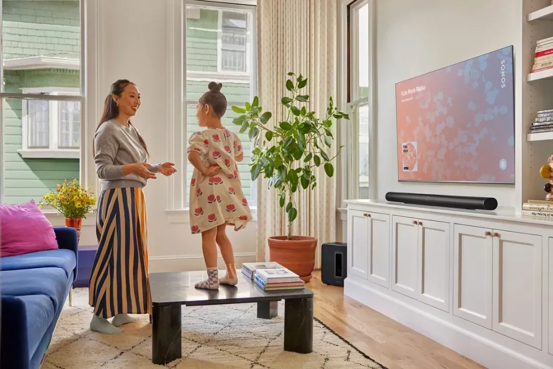 A flat screen tv is sitting on top of a wooden entertainment center.