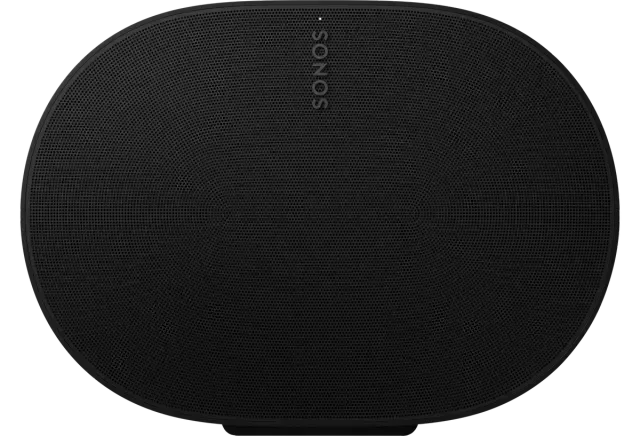 a black sonos speaker is sitting on a white surface .