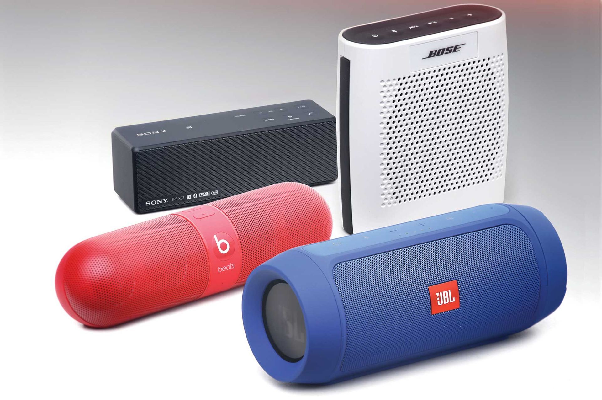 three jbl wireless bluetooth speakers are sitting next to each other