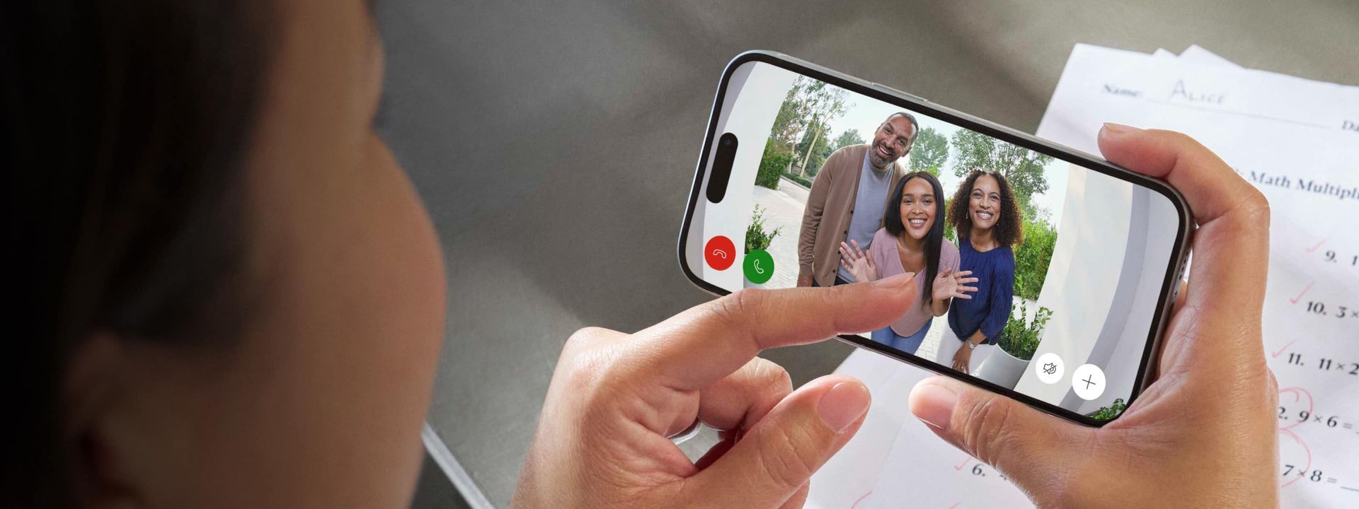 A person is taking a picture of a family on a cell phone.