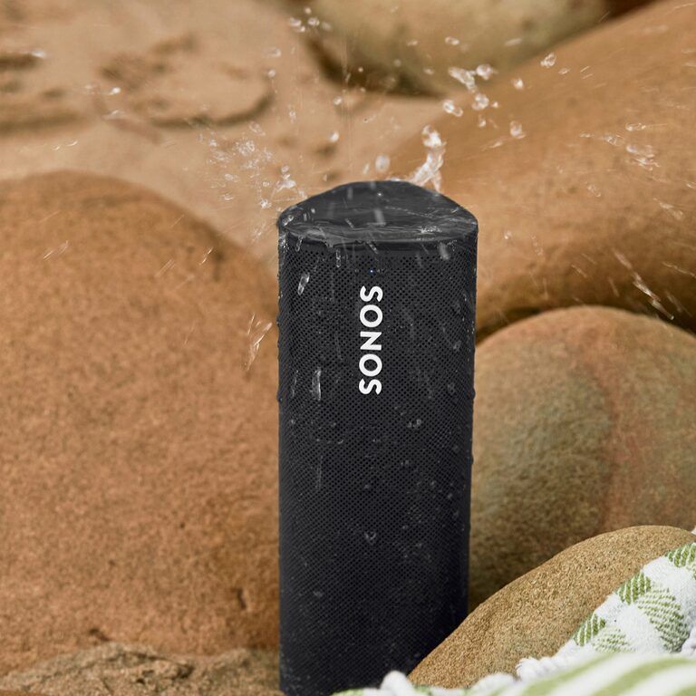 a sonos speaker is sitting on a pile of rocks