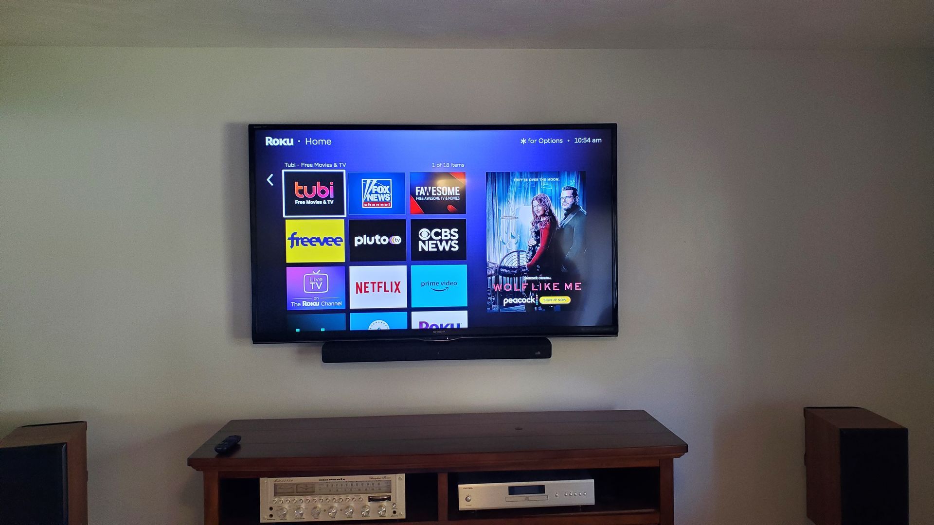 a flat screen tv is mounted to the wall with a soundbar in north central ohio