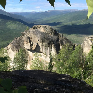 Scenic rocky cliffs and a hiking trail surrounded by forest at Angel Rocks Trail.