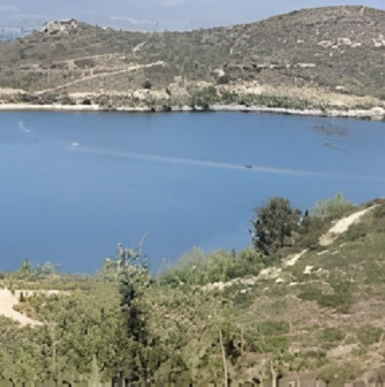 Scenic view of Lake Hodges with calm water, mountains, and hiking trails