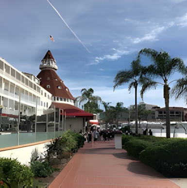 Wide sandy beach with gentle waves and beachgoers at Coronado Beach