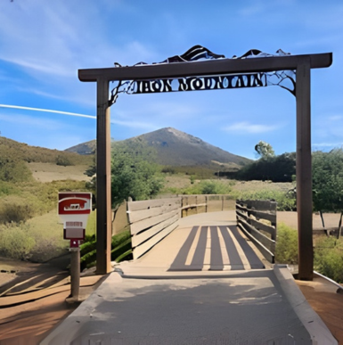 Trailhead sign and hiking path leading up Iron Mountain in Poway.