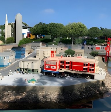 Colorful LEGO-themed entrance with sculptures and families entering LEGOLAND California.