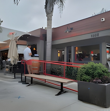Colorful outdoor dining area at Le Papagayo restaurant in Leucadia with live music setup.