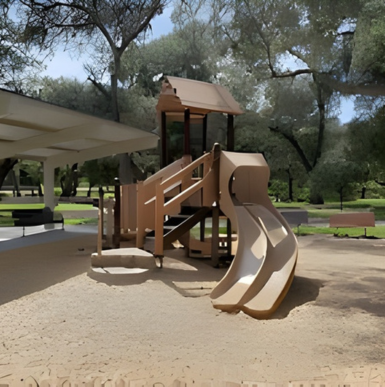 Open grassy fields with picnic areas and large oak trees at Live Oak County Park