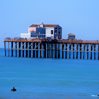 Wide beach view with waves and beachfront buildings in Oceanside