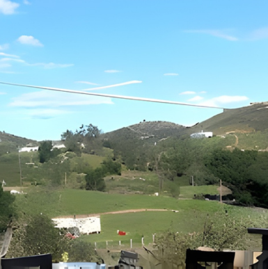 Vineyard rows and tasting patio with rustic charming architecture at Ramona Ranch Winery