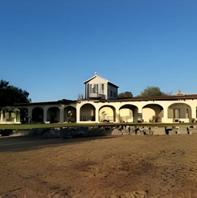 Historic Rancho Guajome Adobe building with whitewashed walls and red tile roof.