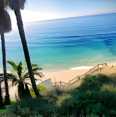 Famous surf spot with rocky cliffs and surfers riding waves at Swami's Beach