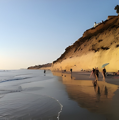 Rocky shoreline and tide pools with visitors exploring at Tide Beach Park