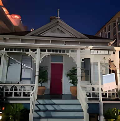 Historic Top Gun movie house with palm trees and blue sky in Oceanside