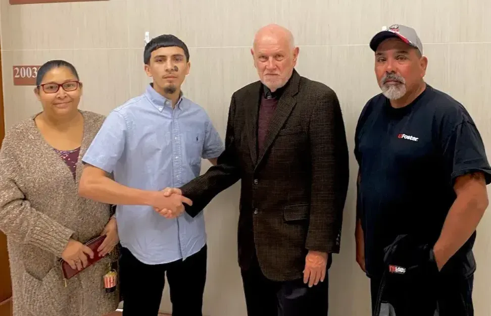 A group of people are shaking hands in a room.