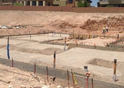 A construction site with a house in the background