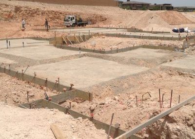 A construction site with a truck parked in the background.
