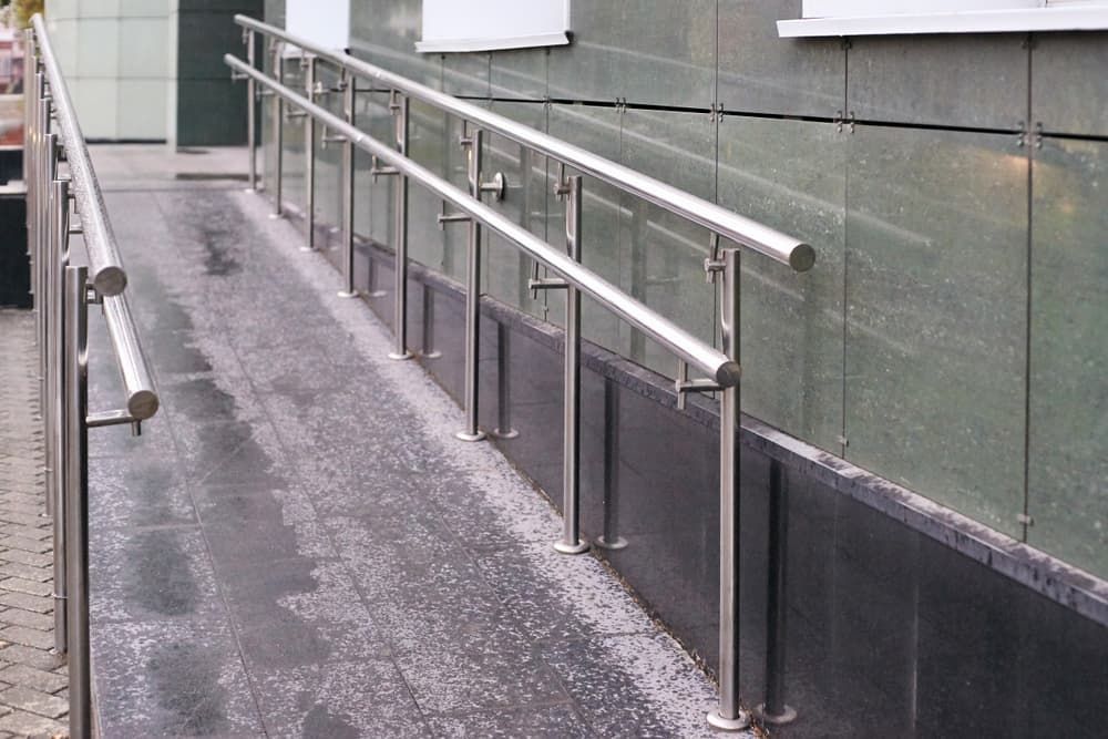 Metal Ramp with Handrails Providing Wheelchair Accessibility — Coastcrete Concrete Specialist in Taylors Beach, NSW