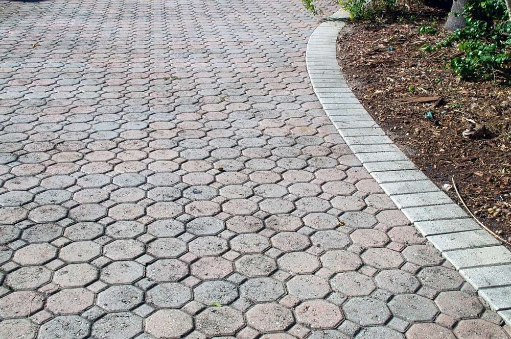 Brick Paver Driveway with A Curved Edge and Landscaping — Coastcrete Concrete Specialist in Tea Gardens, NSW