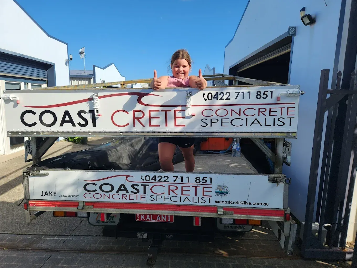 Person giving thumbs up on Coastcrete-branded truck — Coastcrete Concrete Specialist in Taylors Beach, NSW— Coastcrete Concrete Specialist in Taylors Beach, NSW