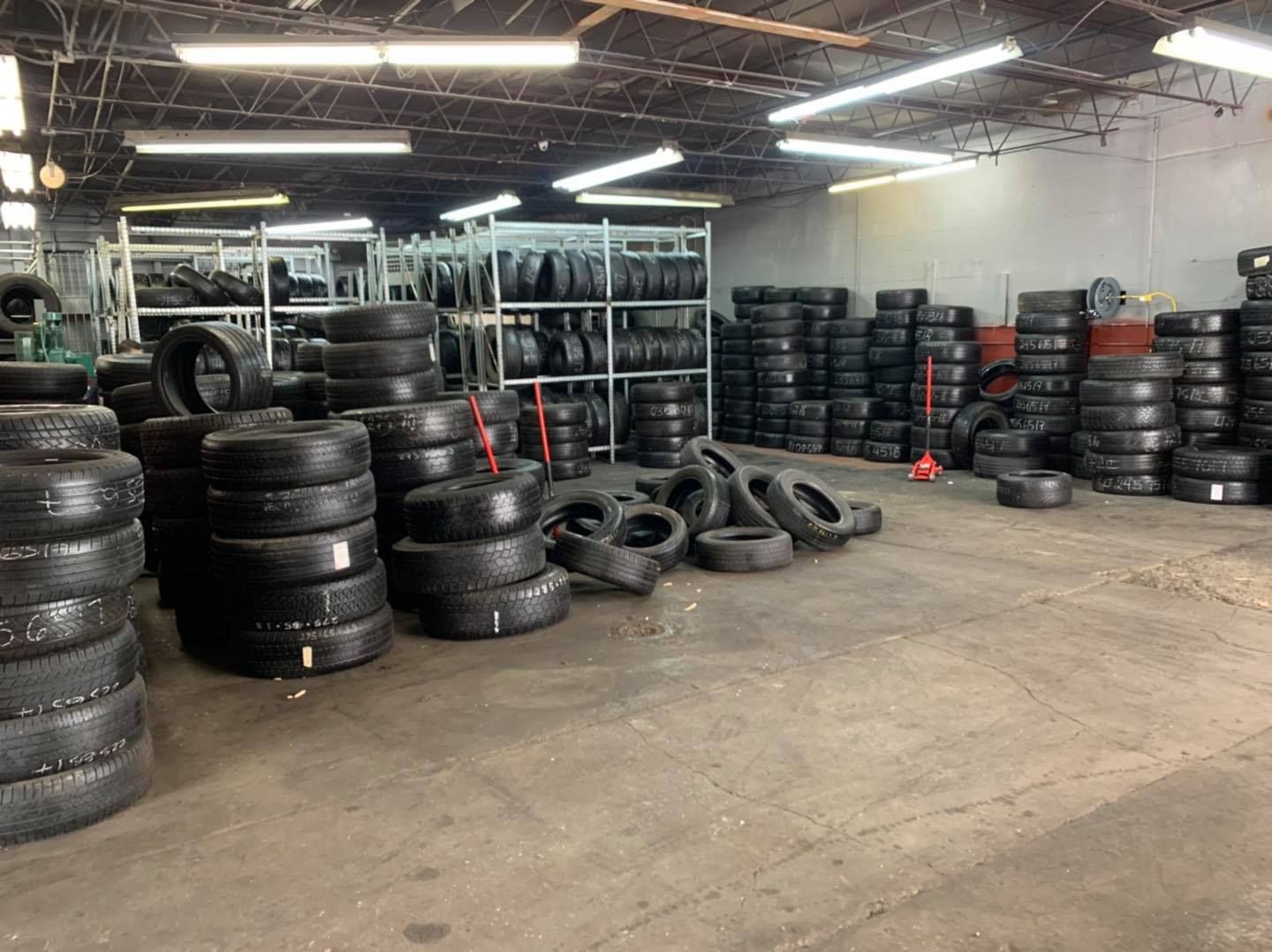 A warehouse filled with lots of tires stacked on top of each other.