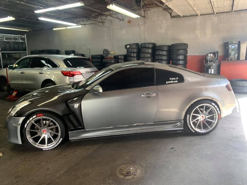 A silver sports car is parked in a garage.