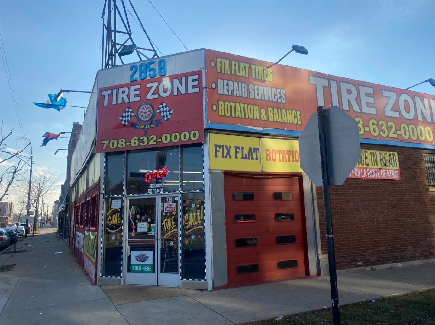 A tire zone store is located on the corner of a street.